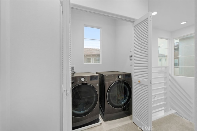 washroom with washing machine and clothes dryer, recessed lighting, and laundry area