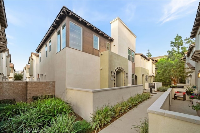 view of home's exterior featuring a fenced front yard and stucco siding