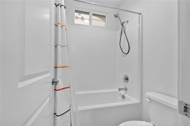 full bath with toilet and shower / bath combo with shower curtain