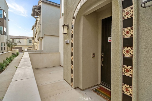 property entrance featuring stucco siding