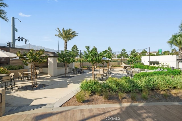 view of community featuring a mountain view and a patio area