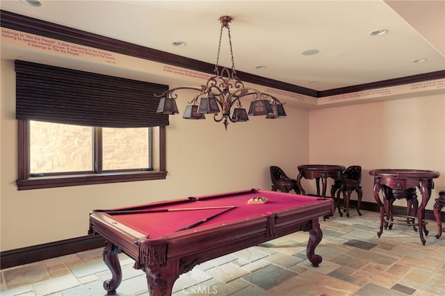 game room featuring stone tile flooring, crown molding, and baseboards