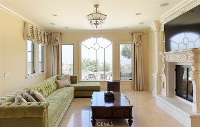 living area with crown molding, light tile patterned floors, a high end fireplace, and a healthy amount of sunlight