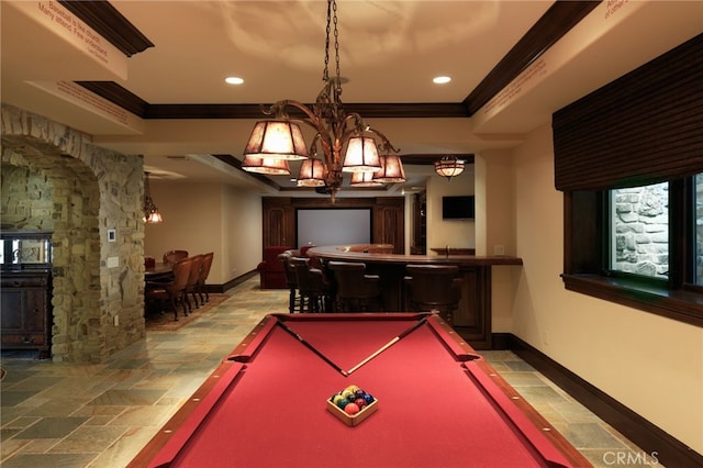 game room with stone tile flooring, a notable chandelier, crown molding, and baseboards