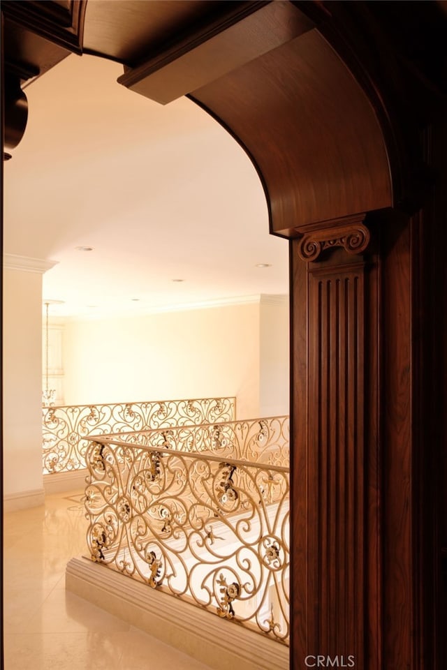 corridor featuring ornamental molding and tile patterned floors