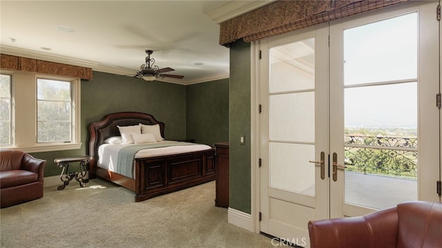 bedroom featuring baseboards, multiple windows, light colored carpet, and crown molding