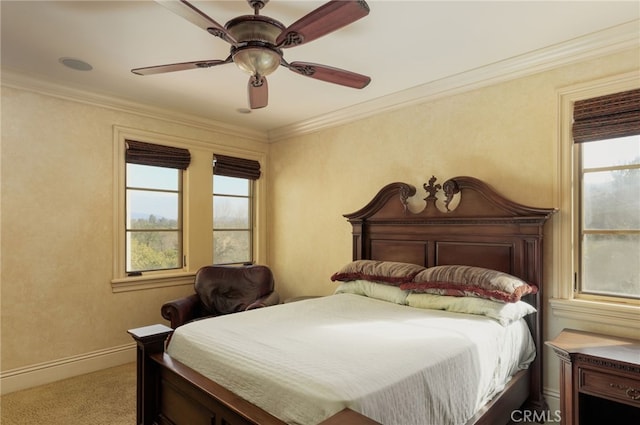 carpeted bedroom with ornamental molding, a ceiling fan, and baseboards