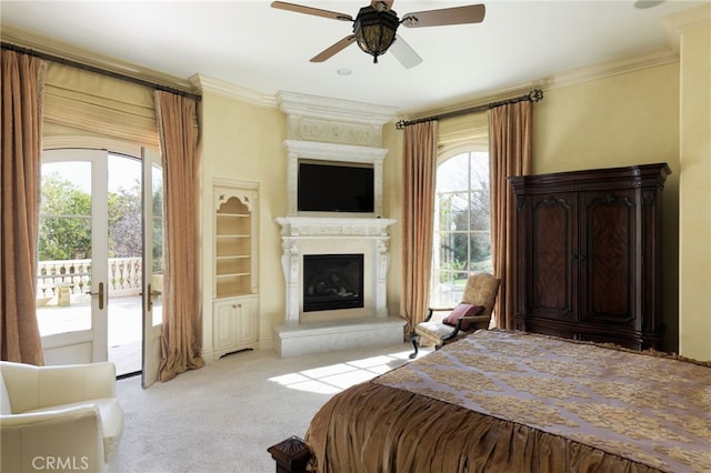 bedroom featuring light carpet, access to exterior, a large fireplace, and crown molding