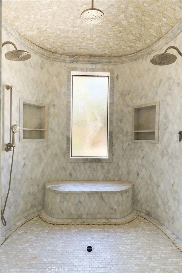 full bath with ornamental molding and tiled shower