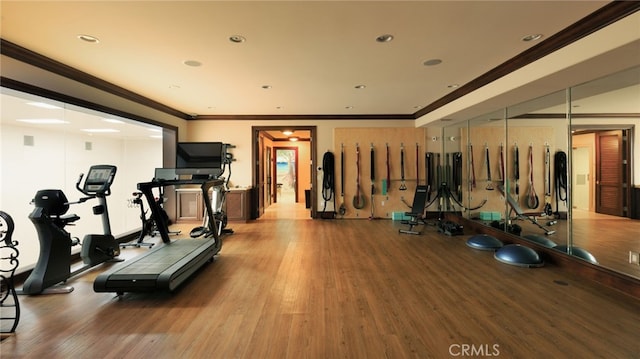 exercise room featuring recessed lighting, crown molding, and wood finished floors