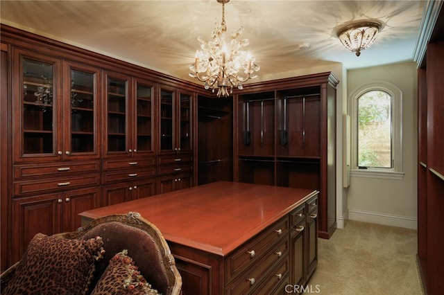 home office with light colored carpet, baseboards, and an inviting chandelier