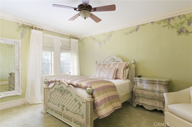 bedroom featuring carpet floors, ornamental molding, and a ceiling fan