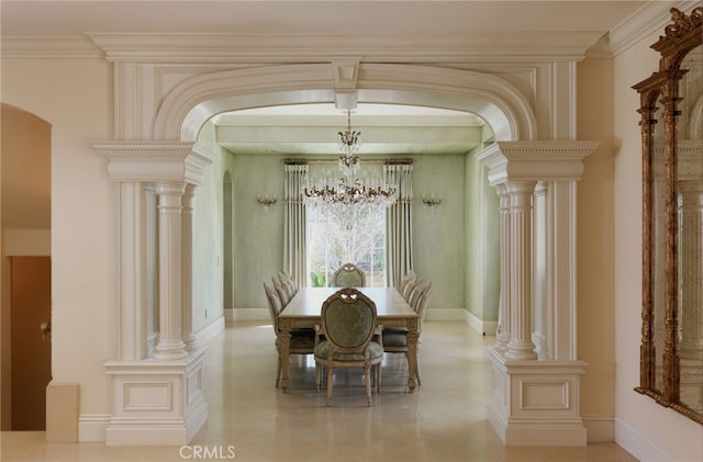 dining area with arched walkways, ornamental molding, decorative columns, and a notable chandelier