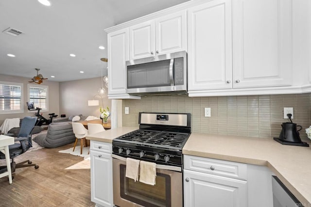 kitchen with light wood finished floors, visible vents, appliances with stainless steel finishes, and light countertops