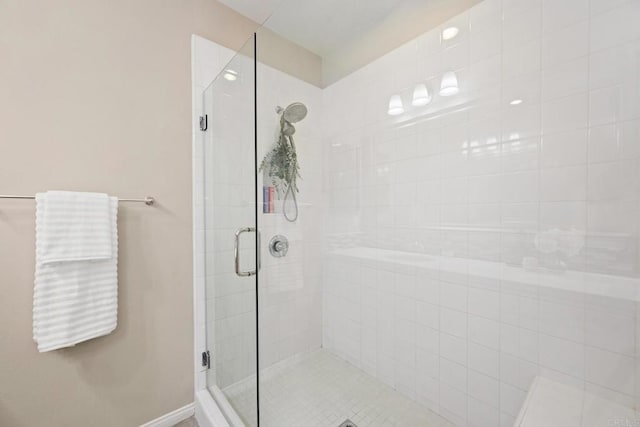 bathroom featuring a stall shower and baseboards