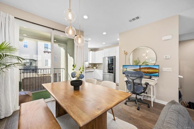 dining room with recessed lighting, visible vents, baseboards, and wood finished floors