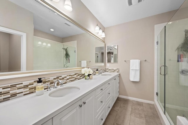 bathroom with a stall shower, a sink, visible vents, and decorative backsplash