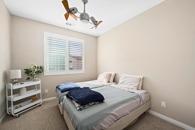 carpeted bedroom featuring ceiling fan, visible vents, and baseboards