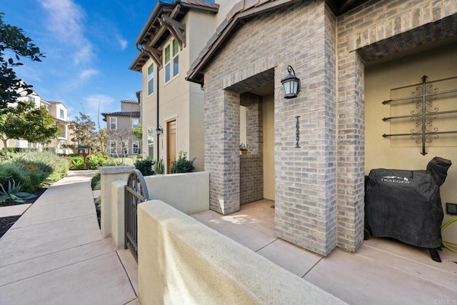 exterior space featuring stucco siding and brick siding