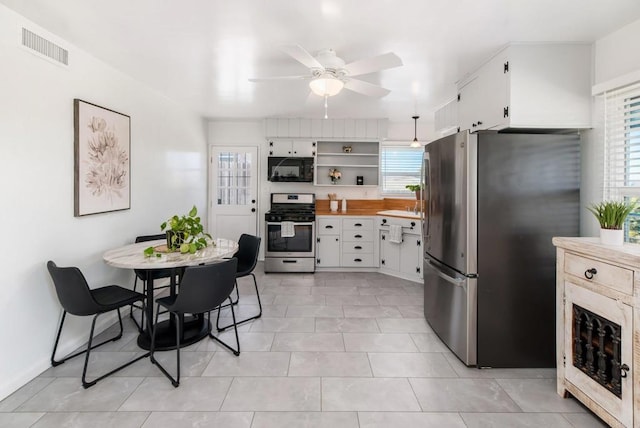 kitchen featuring white cabinets, open shelves, stainless steel appliances, and light countertops