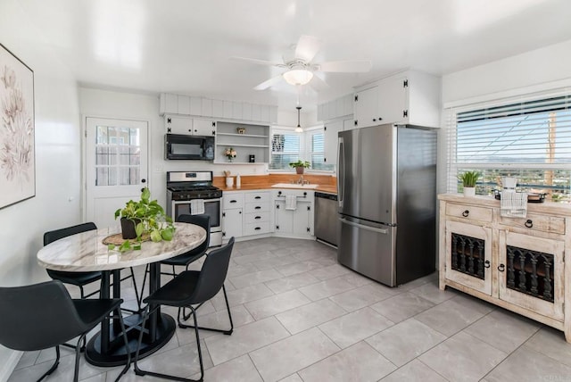 kitchen with white cabinets, ceiling fan, appliances with stainless steel finishes, light countertops, and open shelves