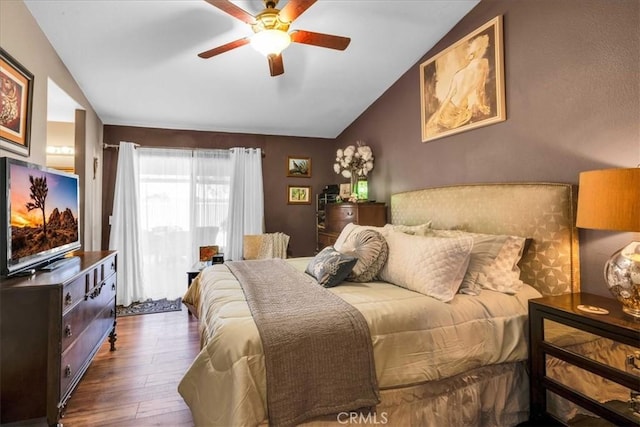 bedroom with lofted ceiling, ceiling fan, and wood finished floors