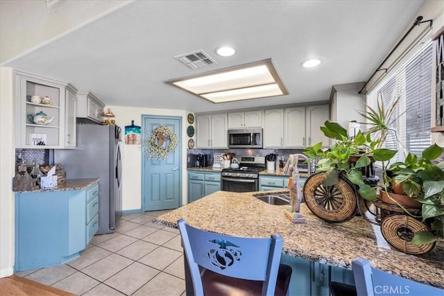 kitchen featuring light tile patterned floors, visible vents, appliances with stainless steel finishes, open shelves, and tasteful backsplash