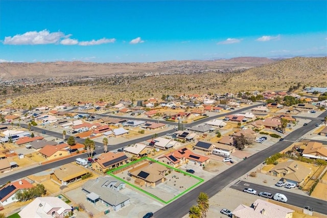 bird's eye view featuring a residential view, a mountain view, and a desert view