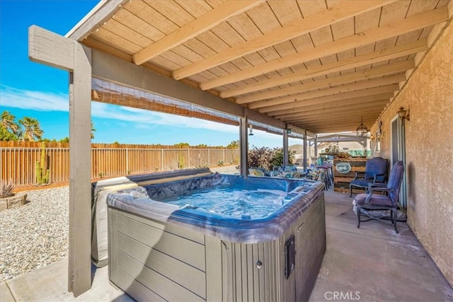 view of patio / terrace featuring a fenced backyard and a hot tub