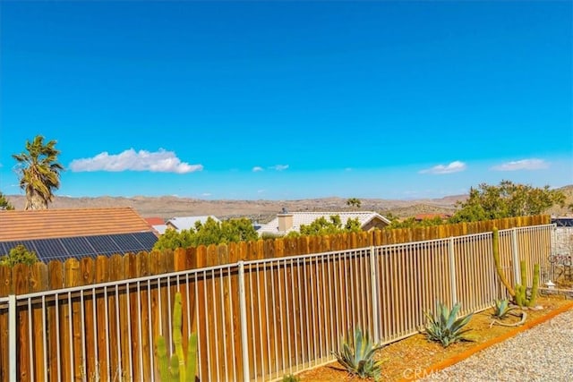 view of yard with a fenced backyard and a mountain view