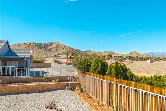 view of yard with a fenced backyard and a mountain view