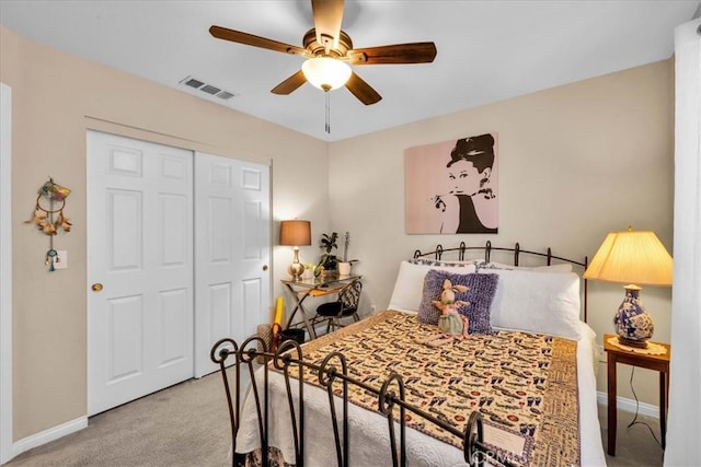 bedroom with baseboards, visible vents, a ceiling fan, carpet flooring, and a closet