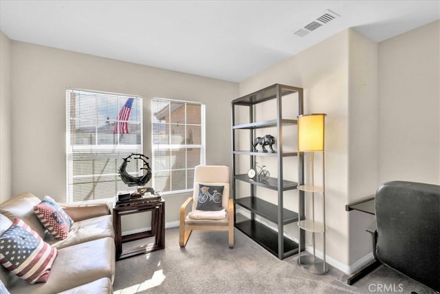 sitting room featuring carpet flooring, visible vents, and baseboards