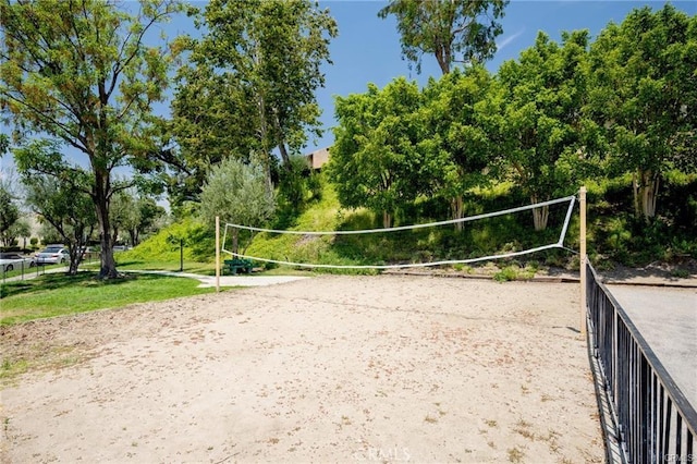 view of property's community featuring fence and volleyball court