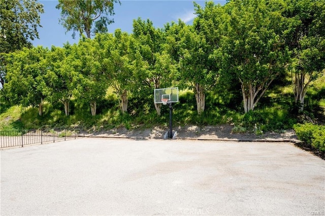 view of basketball court featuring community basketball court and fence