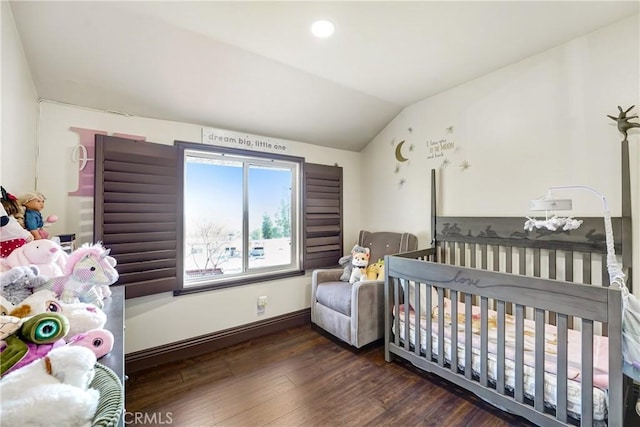 bedroom featuring lofted ceiling, baseboards, and wood finished floors