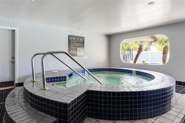 view of swimming pool featuring an indoor hot tub