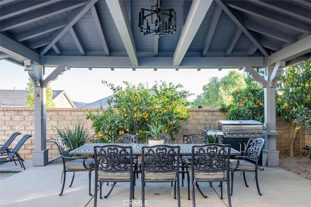 view of patio with a gazebo, outdoor dining area, area for grilling, and fence