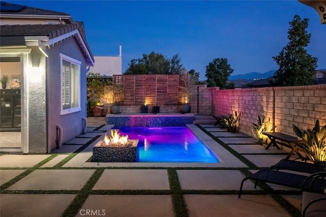 view of pool with a patio, an outdoor fire pit, a fenced backyard, and a fenced in pool