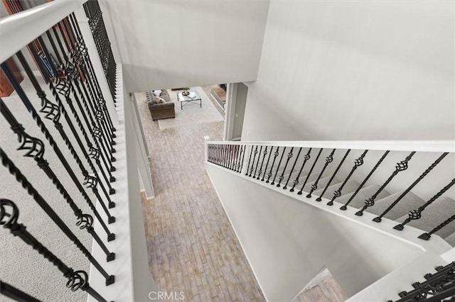 stairs featuring wood finished floors