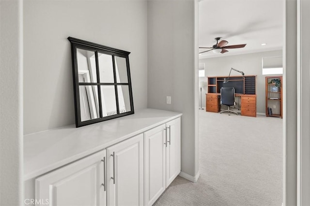 hallway with light colored carpet