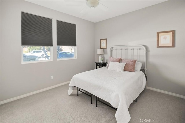 carpeted bedroom with a ceiling fan and baseboards