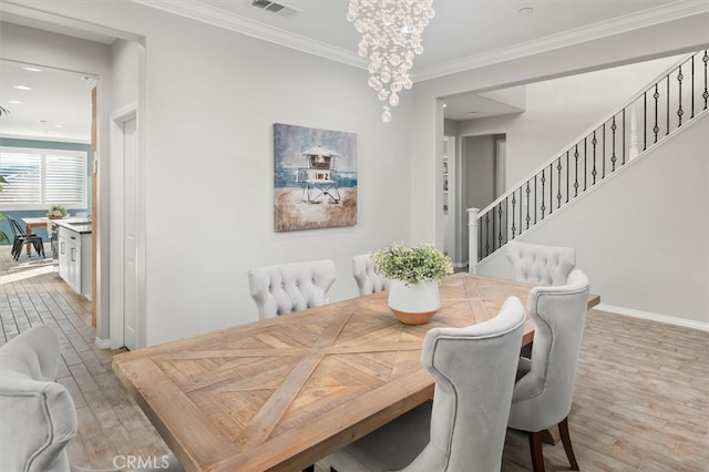 dining area featuring a notable chandelier, wood finished floors, baseboards, ornamental molding, and stairway