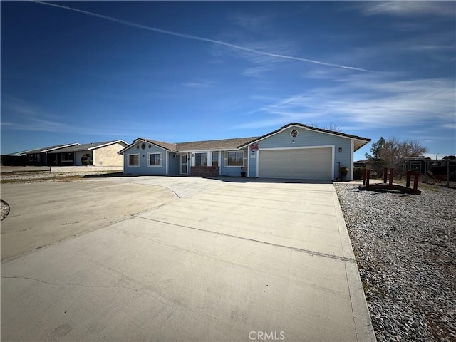 ranch-style house featuring driveway and a garage