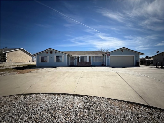 ranch-style house with an attached garage and concrete driveway