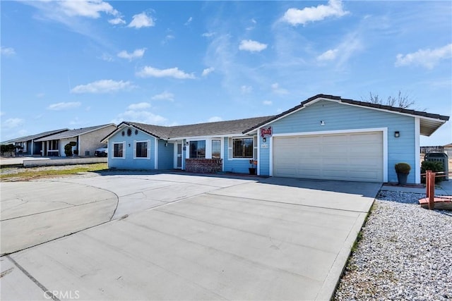 view of front of home with concrete driveway and an attached garage