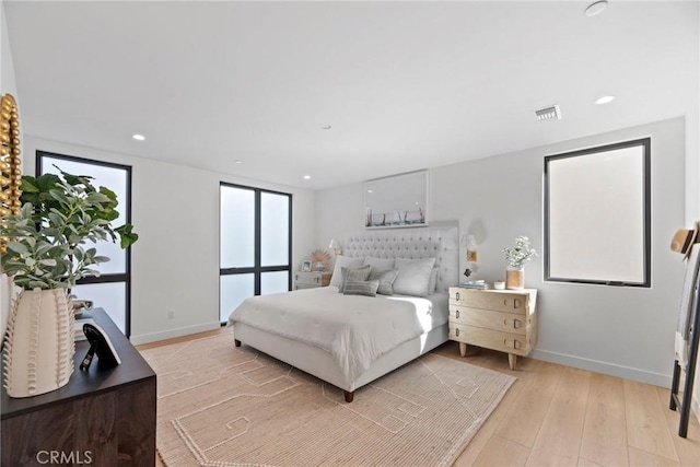 bedroom featuring recessed lighting, light wood-type flooring, visible vents, and baseboards