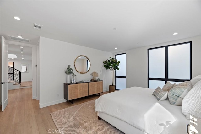 bedroom featuring baseboards, recessed lighting, visible vents, and light wood-style floors