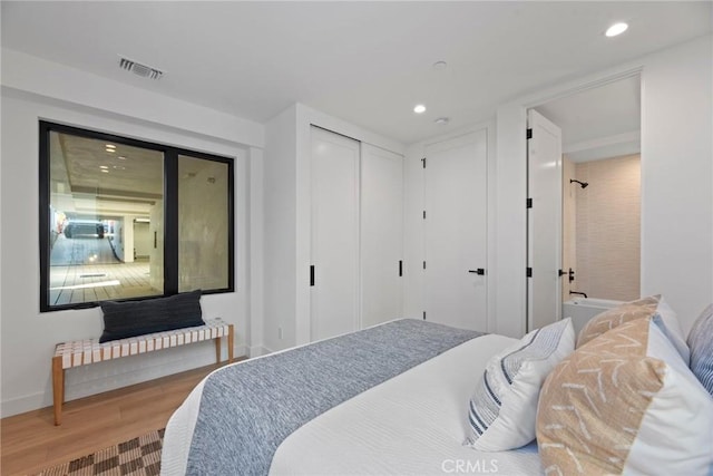 bedroom featuring recessed lighting, a closet, visible vents, wood finished floors, and baseboards