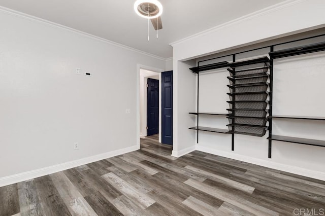 unfurnished bedroom featuring ceiling fan, baseboards, wood finished floors, and crown molding